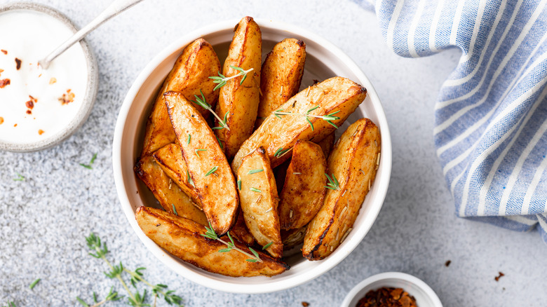 potato wedges in white bowl