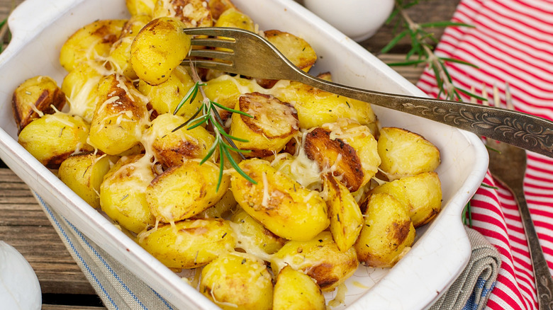 cheesy roasted potatoes in white dish