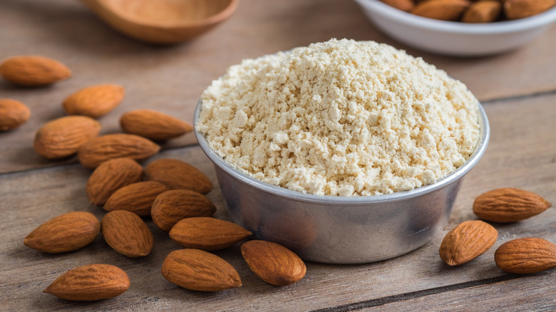 almond flour in a bowl with almonds on the table