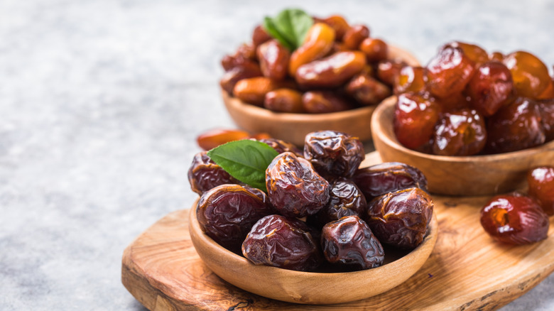 Assorted dates in wooden bowls