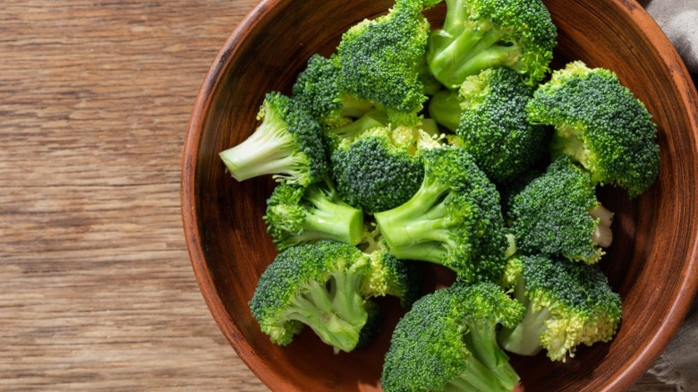 Broccoli florets in wooden bowl