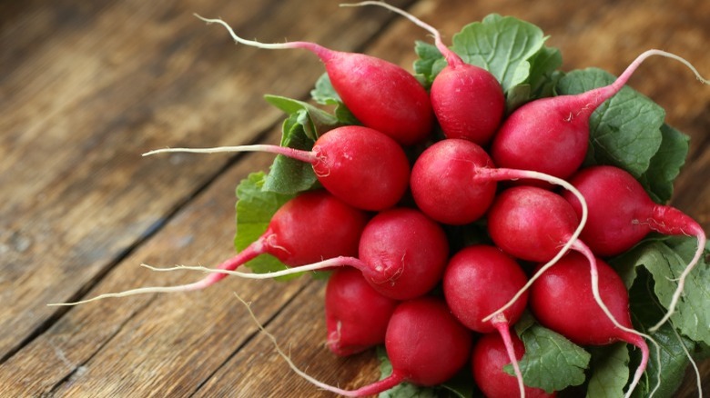 Bunch of red radishes on table