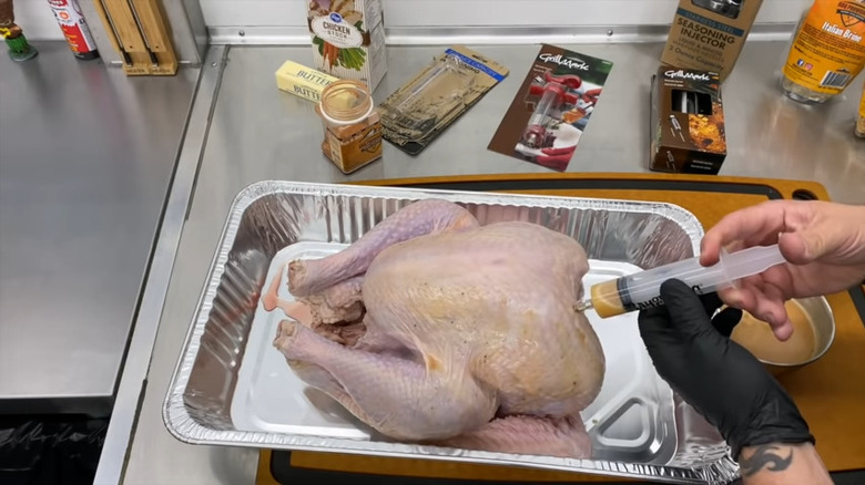 person Injecting turkey