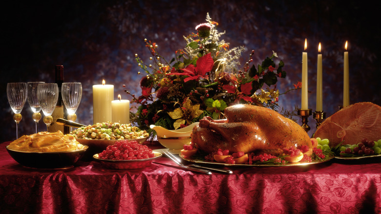 Turkey on a table with festive sides