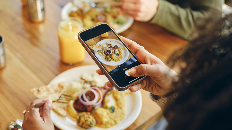 Person posting food pictures on social media