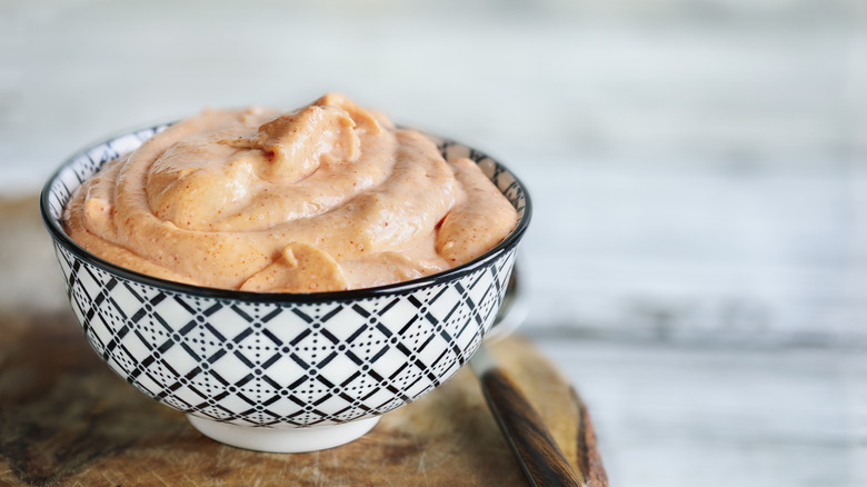 bowl of mayonnaise flavored with herbs and spices