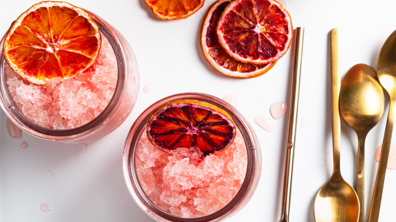 frozen pink cocktails with orange wheel