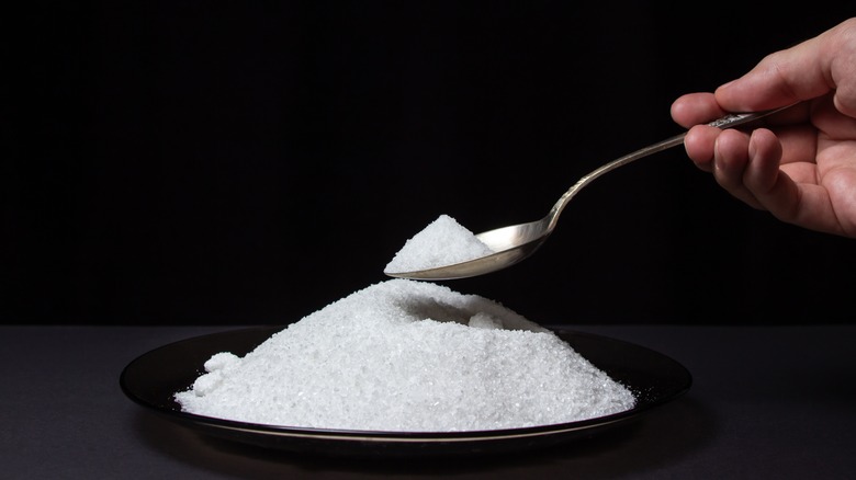 spooning a pile of salt