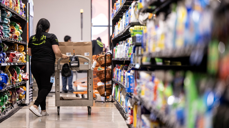 Grocery store employee stocking shelves