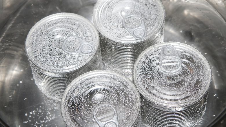 Cans boiling in a pot