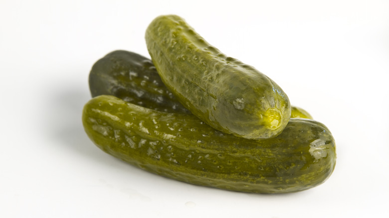 Three pickles on white background