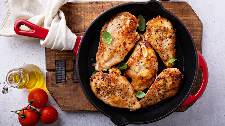 seasoned chicken in a skillet on a trivet