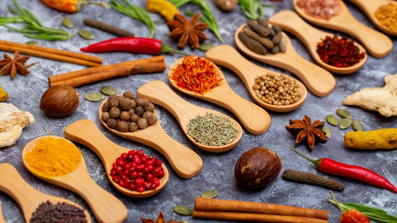 an assortment of spices on wooden spoons