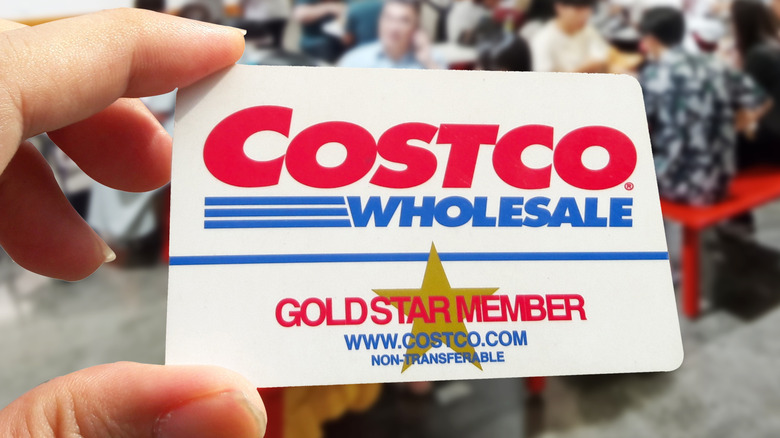 Hand holding Costco Gold Star memberhsip card