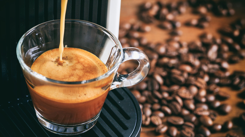 Espresso shot being pulled with beans