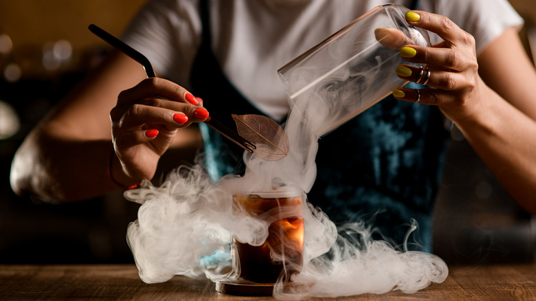 Bartender smoking an iced cocktail