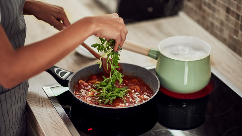 Woman making pasta dinner