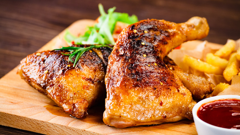 Chicken legs on wooden board