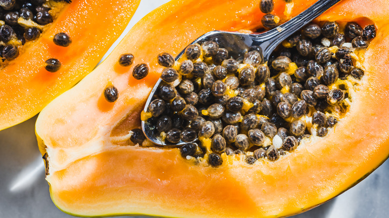 papaya seeds with a spoon