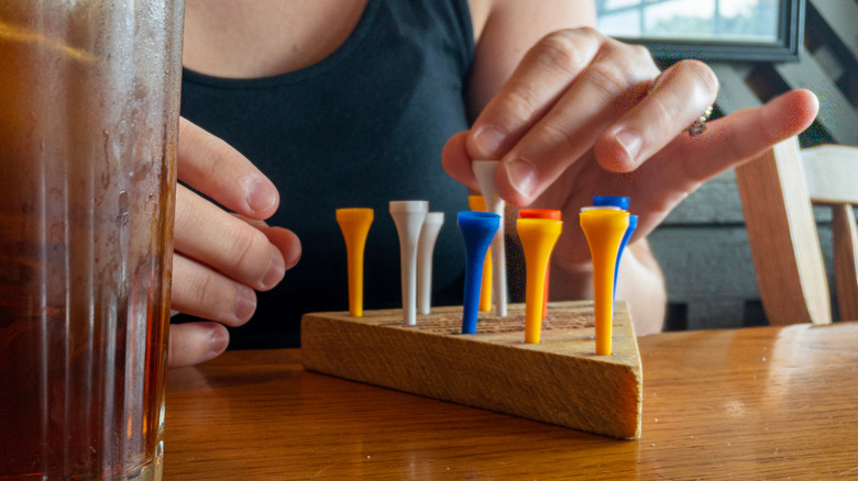 A person plays the peg game