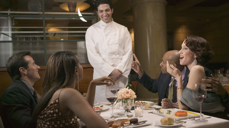 customers and servers at a fine dining restaurant