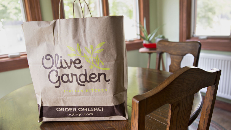 Takeout bag from Olive Garden on a wooden table