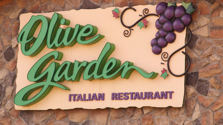 olive garden sign against stone wall