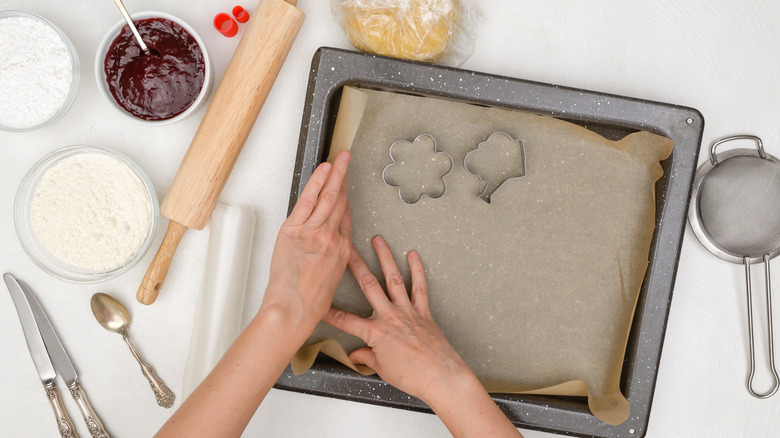 lining a baking sheet with parchment paper