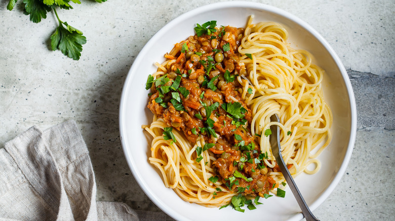 Spaghetti with lentil bolognese on white countertop