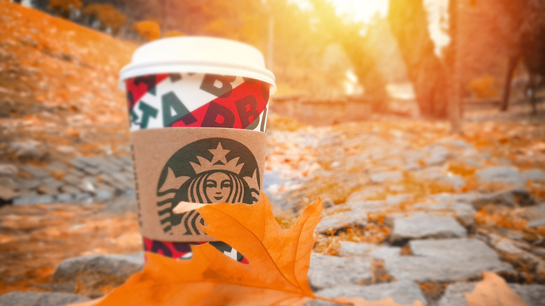 A Starbucks covered by an orange leaf