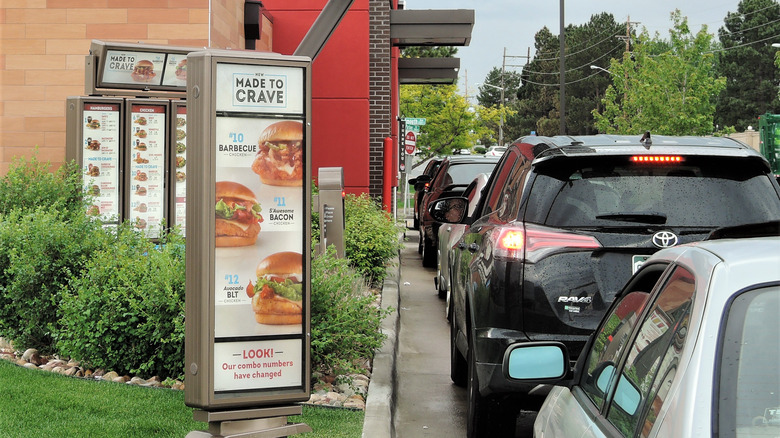 Cars waiting in line at a drive-thru window