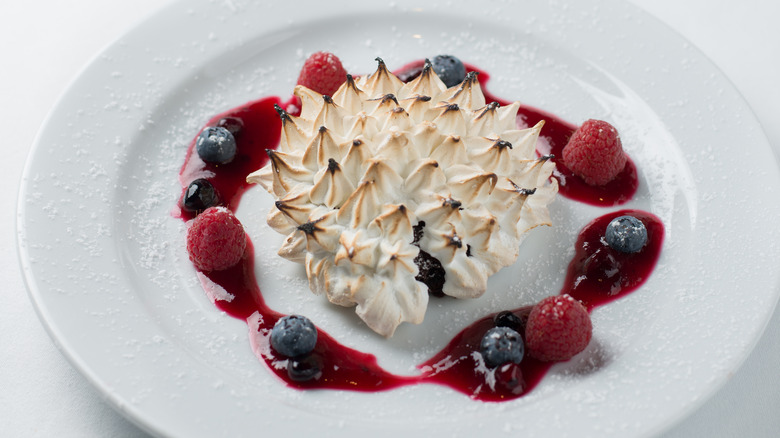 Baked Alaska surrounded by fruit 