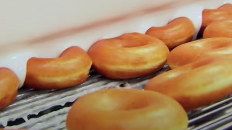 Krispy Kremes being glazed