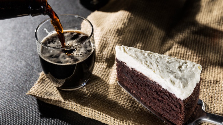 Slice of Guinness cake alongside glass of guinness