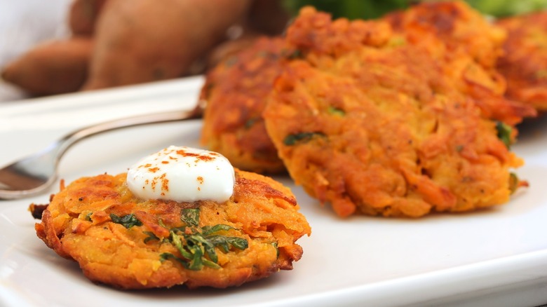 A dollop of sour cream spooned onto a potato pancake