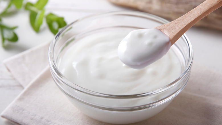 Spooning cream out of a small glass bowl