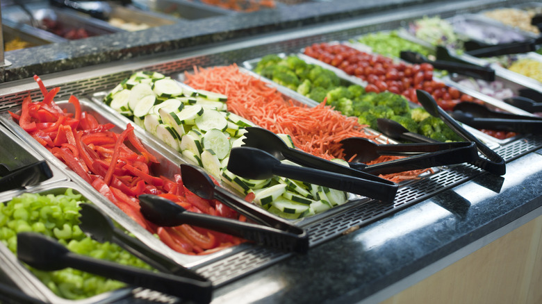 tongs lying on salad bar