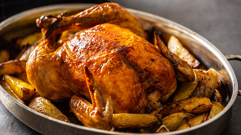 Roast chicken in pan with potatoes