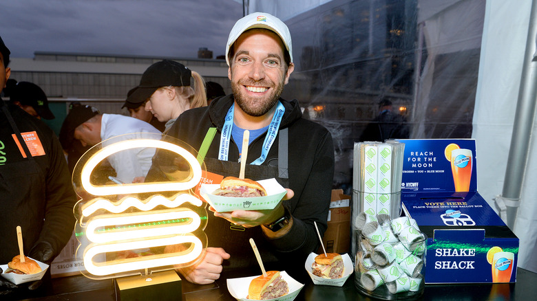 Mark Rosati holding a burger