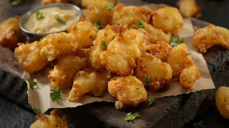 fried cheese curds on wooden board