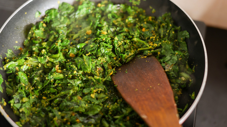 green leaves and lentils in a bowl