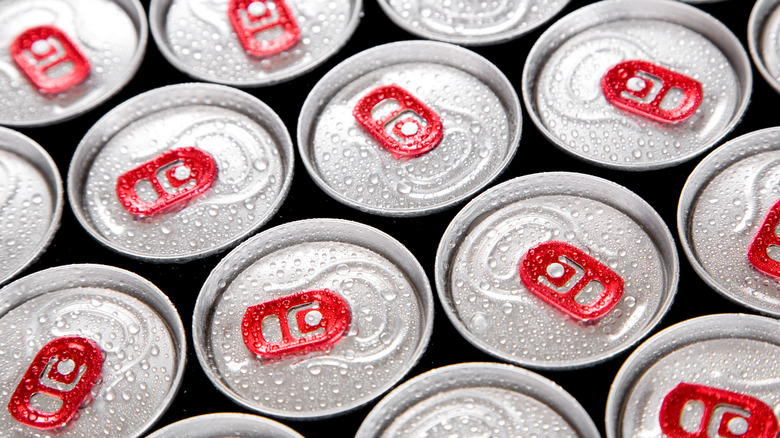 tops of canned beverages with condensation