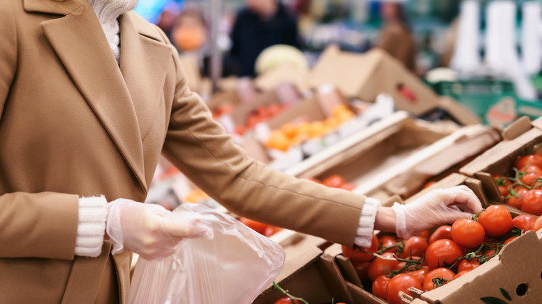 Woman buying tomatoes