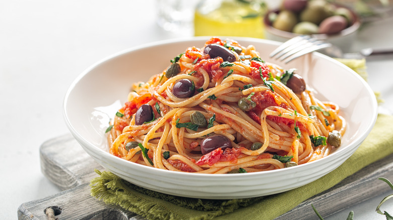 bowl of Italian pasta with olives and tomatoes
