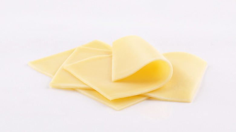 Sliced cheese on white background