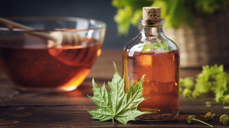 Corked glass jar of maple syrup.