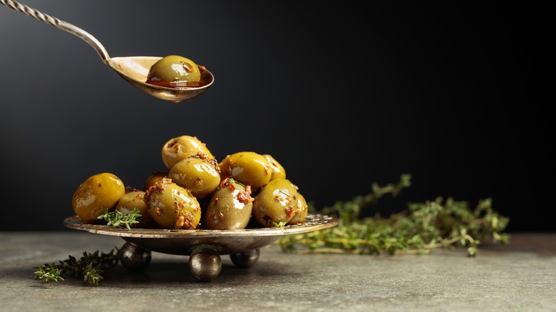 Green olives on tiny metal tray