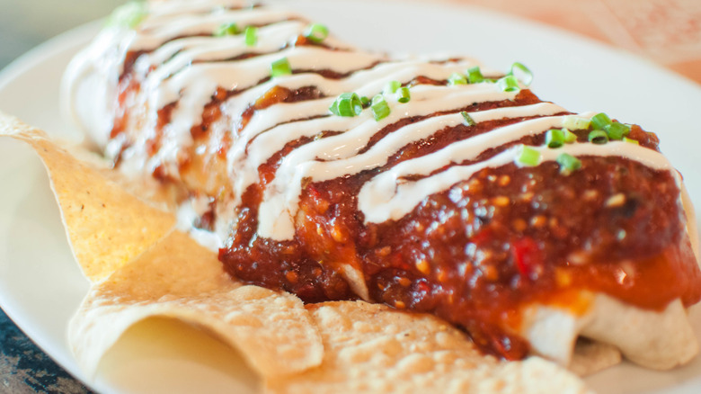 burrito with sauce and sour cream