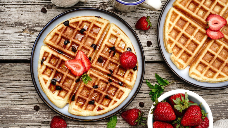 Plates of waffles with strawberries