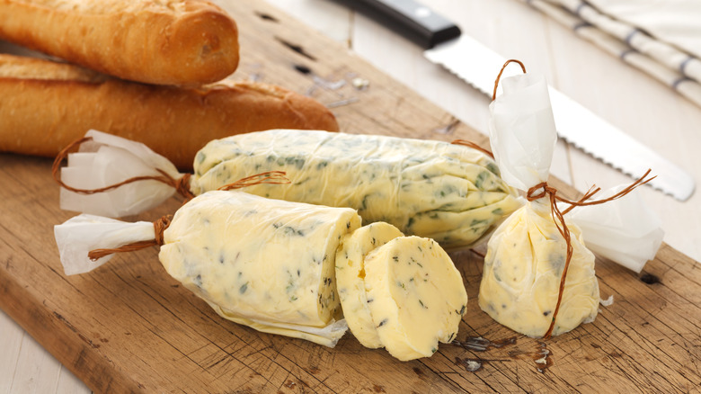 compound butter on wooden board with baguette